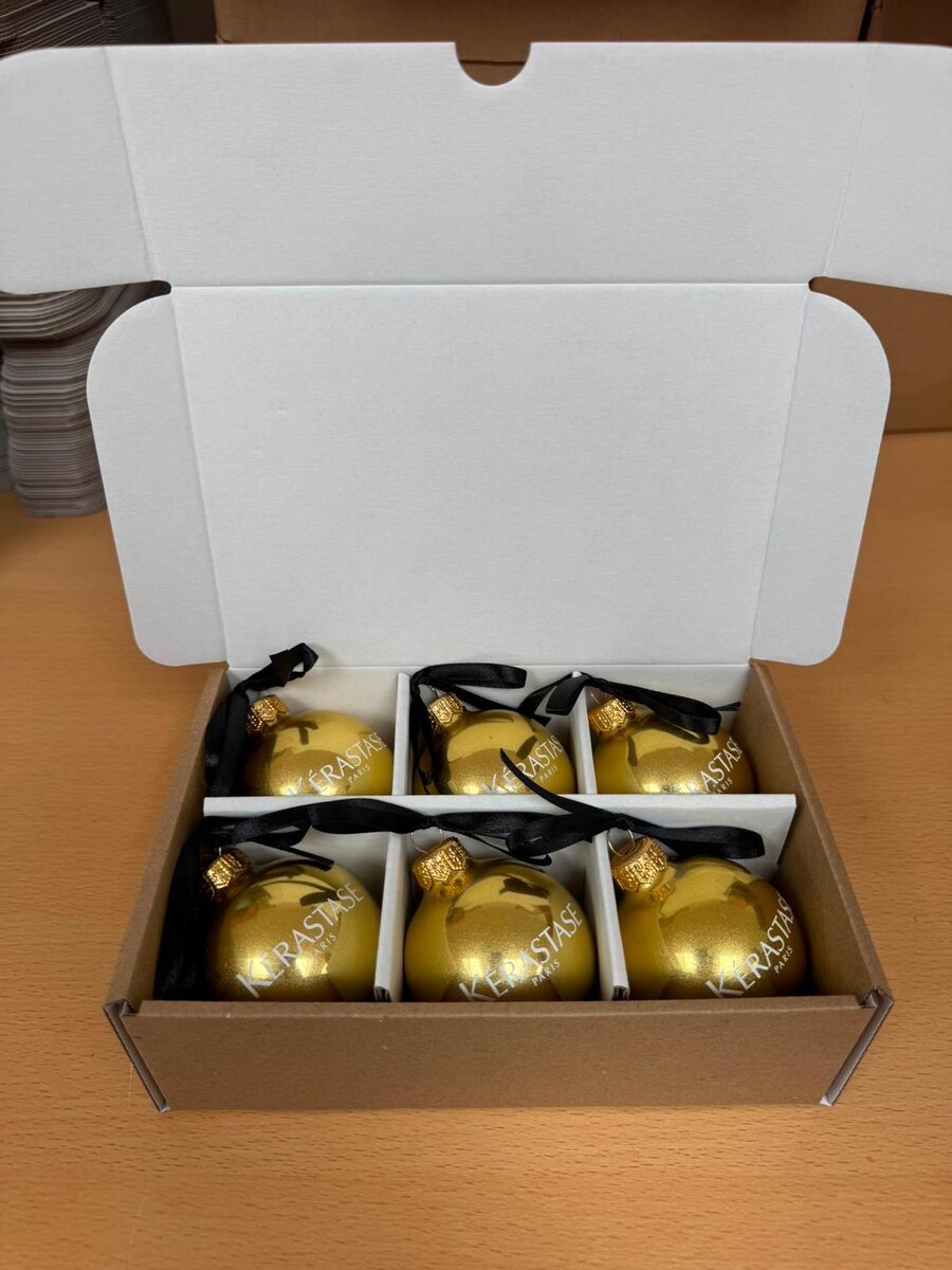 Boxed set of six gold Kérastase-branded Christmas baubles